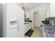 Bright kitchen with white cabinetry, stainless appliances, and tiled floor at 2903 Pope St, North Port, FL 34287