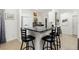 Kitchen bar with black stools and stone countertops at 2903 Pope St, North Port, FL 34287