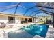 Screened-in pool with attached jacuzzi and a spacious pool deck perfect for entertaining at 2903 Pope St, North Port, FL 34287