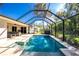 View of the pool area with lush landscaping and relaxing sitting areas at 2903 Pope St, North Port, FL 34287