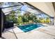 A screened-in pool area with lush landscaping that offers a private oasis at 2903 Pope St, North Port, FL 34287
