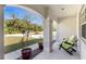 Cozy front porch with comfortable chairs, potted plants, decorative columns, and stone accents at 2903 Pope St, North Port, FL 34287