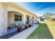 Inviting front porch with decorative columns, walkway, and colorful potted plants, and seating at 2903 Pope St, North Port, FL 34287