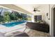 Screened porch with ample seating, offering a serene view of the inviting pool at 2903 Pope St, North Port, FL 34287