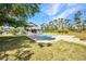 Inviting backyard with a sparkling pool and tiki hut, perfect for outdoor entertaining and relaxation at 29324 Leah Rd, Punta Gorda, FL 33982