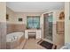 Luxurious bathroom featuring soaking tub, vanity and glass enclosed shower at 29324 Leah Rd, Punta Gorda, FL 33982