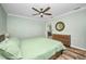 Bright bedroom with a wood-look floor, and sage green walls and bedspread at 29324 Leah Rd, Punta Gorda, FL 33982