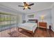 This bedroom has wood floors and sliding glass doors to the patio at 29324 Leah Rd, Punta Gorda, FL 33982