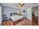 This well lit bedroom offers hardwood floors and a ceiling fan at 29324 Leah Rd, Punta Gorda, FL 33982
