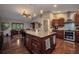 Spacious kitchen with a central island, granite countertops, and stainless steel appliances, providing a gathering spot at 29324 Leah Rd, Punta Gorda, FL 33982