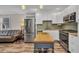 Bright kitchen with stainless appliances, white cabinets, and a movable kitchen island at 29324 Leah Rd, Punta Gorda, FL 33982