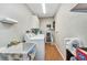 Well-lit laundry room with modern appliances, storage shelves, and ample space for all your laundry needs at 29324 Leah Rd, Punta Gorda, FL 33982