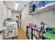 Efficient laundry room with a washer, dryer, shelving, and storage space for cleaning supplies at 29324 Leah Rd, Punta Gorda, FL 33982