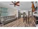 Bright open floor plan with wood-look floors and modern ceiling fan and stainless steel appliances at 29324 Leah Rd, Punta Gorda, FL 33982