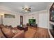 Cozy living room features hardwood floors, a ceiling fan, and a decorative front door at 29324 Leah Rd, Punta Gorda, FL 33982
