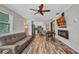 Bright living room with a faux fireplace and mounted television, with an open floor plan at 29324 Leah Rd, Punta Gorda, FL 33982
