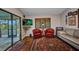 Comfortable living room boasts sliding door access to porch, patterned rug, plush seating, and a large window at 29324 Leah Rd, Punta Gorda, FL 33982