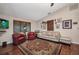 Comfortable living room with a patterned rug, plush seating, and a large window providing natural light at 29324 Leah Rd, Punta Gorda, FL 33982