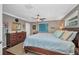 Comfortable main bedroom features a wood-framed bed, ceiling fan, dresser and carpet at 29324 Leah Rd, Punta Gorda, FL 33982