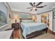 Main bedroom with large bed, and ensuite bath features a large window with blind at 29324 Leah Rd, Punta Gorda, FL 33982