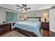 Main bedroom with large bed, and bedside tables features large windows with blinds at 29324 Leah Rd, Punta Gorda, FL 33982