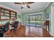 Bright office featuring built-in shelving, a ceiling fan, and sliding glass doors to the outside at 29324 Leah Rd, Punta Gorda, FL 33982