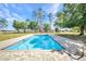 Sparkling in-ground pool with brick paver surround and clear blue skies at 29324 Leah Rd, Punta Gorda, FL 33982