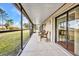 Relaxing screened porch with tile flooring and comfortable seating overlooking the backyard at 29324 Leah Rd, Punta Gorda, FL 33982