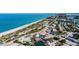 A coastal view of the sandy beach with restaurants in the distance and vibrant beachside community at 352 Oak St, Englewood, FL 34223