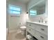 Modern bathroom with a large mirror, updated vanity, and a tiled shower/tub combination at 352 Oak St, Englewood, FL 34223