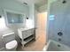 Bright bathroom features a vanity with storage, toilet, and shower with modern fixtures at 352 Oak St, Englewood, FL 34223