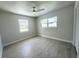 Bright bedroom with two large windows, tile floors, a ceiling fan, and neutral paint at 352 Oak St, Englewood, FL 34223