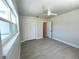 This bedroom features tile floors, a closet, a ceiling fan, and a large window for ample natural light at 352 Oak St, Englewood, FL 34223