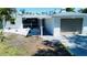 Exterior view of the house featuring a screened in porch, one car garage, and rock landscaping at 352 Oak St, Englewood, FL 34223