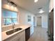 Bright kitchen featuring white cabinets, stainless steel appliances, and quartz countertops at 352 Oak St, Englewood, FL 34223