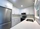 Bright kitchen featuring white cabinets, stainless steel appliances, and quartz countertops at 352 Oak St, Englewood, FL 34223