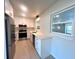 Bright kitchen featuring white cabinets, stainless steel appliances, and quartz countertops at 352 Oak St, Englewood, FL 34223