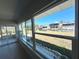 Enclosed porch with view of the water, other houses, and green lawn at 352 Oak St, Englewood, FL 34223