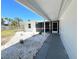 Screened in patio with a view of a serene outdoor space with manicured landscaping at 352 Oak St, Englewood, FL 34223