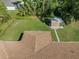 Aerial view of the home showcasing the roof, backyard, and shed at 3621 Jade St, North Port, FL 34288