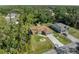 Aerial view of home with a well-manicured lawn, an oversized driveway, and mature landscaping at 3621 Jade St, North Port, FL 34288