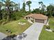 Lovely house aerial featuring a long driveway, two-car garage, and a pristine green lawn at 3621 Jade St, North Port, FL 34288