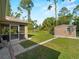 Backyard with shed, landscaped path, and screened patio at 3621 Jade St, North Port, FL 34288