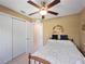 Comfortable bedroom with ceiling fan, closet and white and blue themed decor, great for a restful night's sleep at 3621 Jade St, North Port, FL 34288