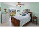 Tranquil bedroom with a large window, ceiling fan, and a comfortable bed at 3621 Jade St, North Port, FL 34288
