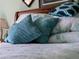 Close-up of bed with pillows and bedding and sea themed accents at 3621 Jade St, North Port, FL 34288