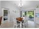 Bright dining area with a view of the backyard and stylish furnishings and light fixture at 3621 Jade St, North Port, FL 34288