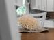 Elegant dining table centerpiece, next to a window and kitchen, suggesting a bright eating space at 3621 Jade St, North Port, FL 34288