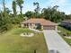 Charming single-Gathering home with an expansive lawn and a spacious two-car garage at 3621 Jade St, North Port, FL 34288