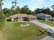 Lovely single-Gathering home with green lawn, long driveway and attached garage at 3621 Jade St, North Port, FL 34288